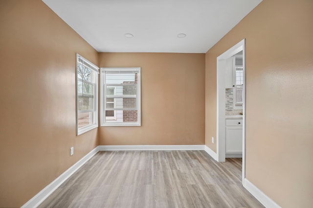 empty room with light hardwood / wood-style floors