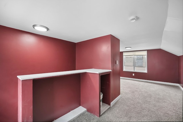 interior space with light carpet and lofted ceiling