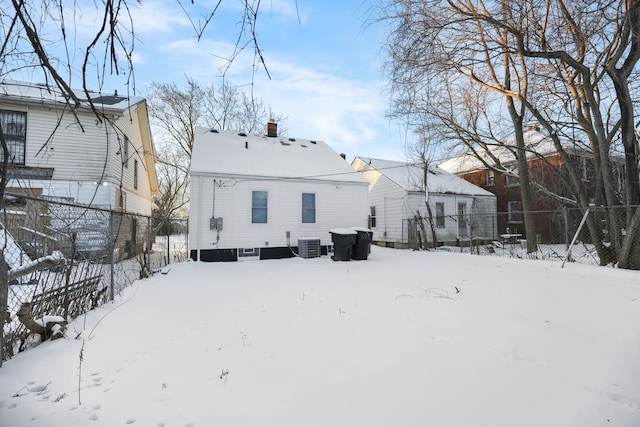 snow covered house with cooling unit