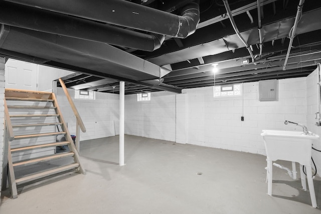 basement featuring electric panel and plenty of natural light