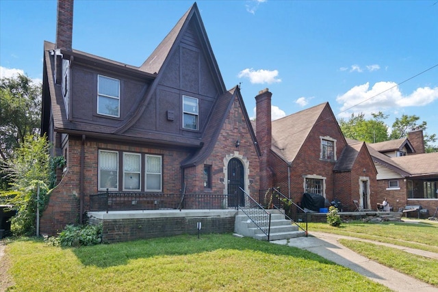 tudor-style house with a front lawn