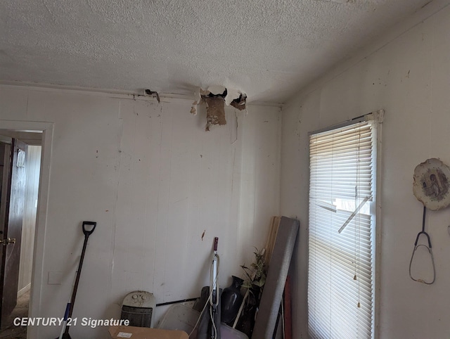 miscellaneous room with a textured ceiling