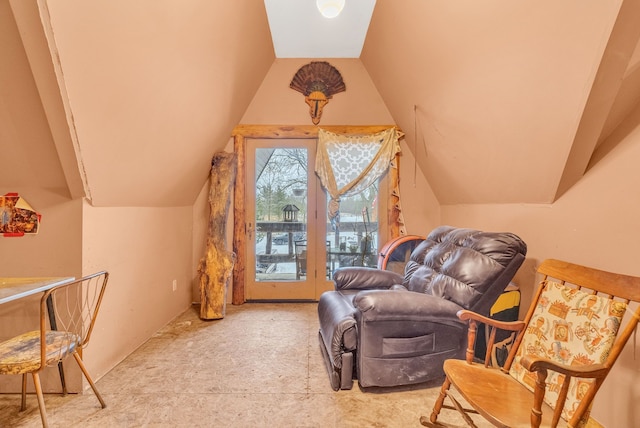 sitting room featuring lofted ceiling