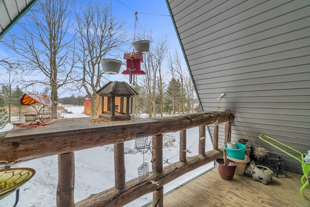 snow covered deck featuring a fireplace