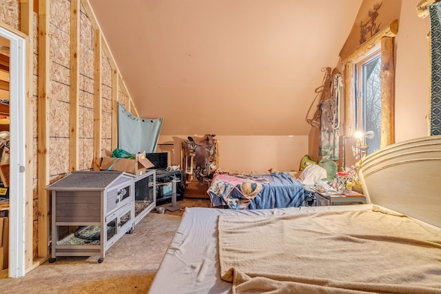 bedroom featuring lofted ceiling and light carpet