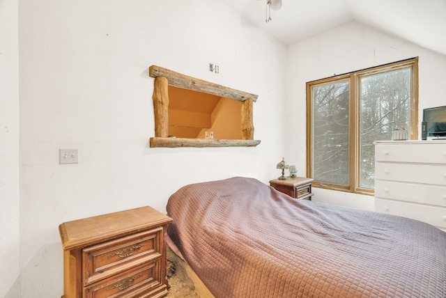 bedroom featuring vaulted ceiling and multiple windows