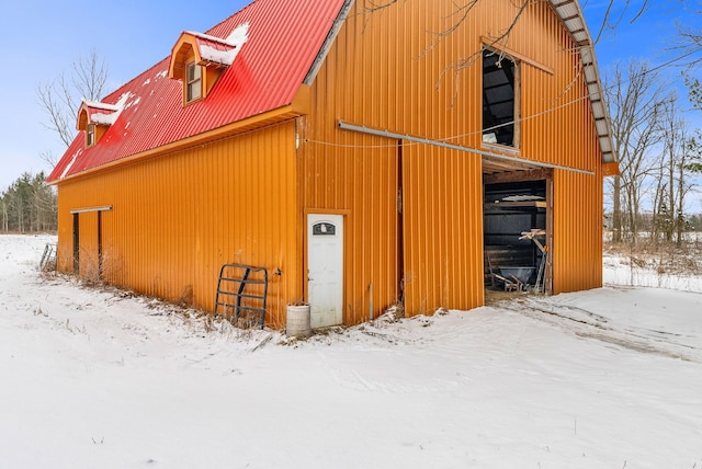 view of snow covered exterior featuring an outdoor structure