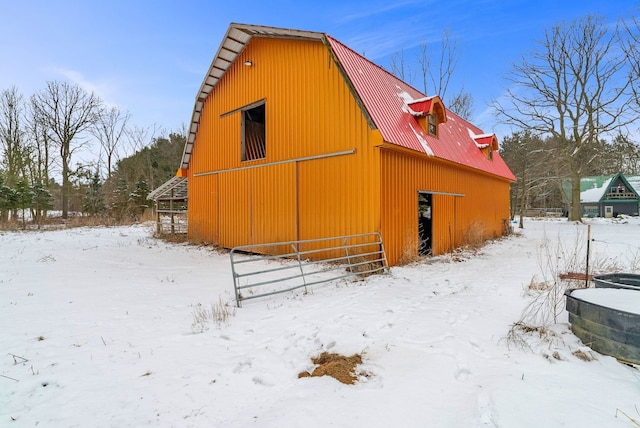 view of snow covered exterior featuring an outdoor structure