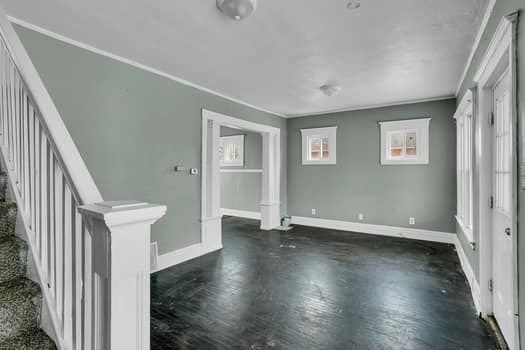 interior space with baseboards and ornamental molding