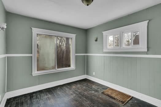 empty room with dark wood-type flooring