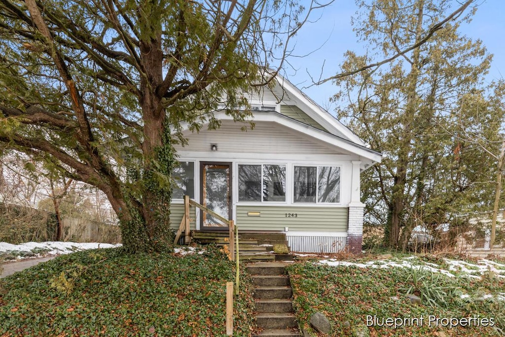 view of front of home with a sunroom