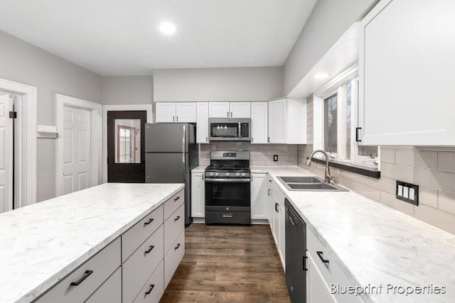 kitchen featuring stainless steel appliances, white cabinetry, sink, and dark hardwood / wood-style flooring