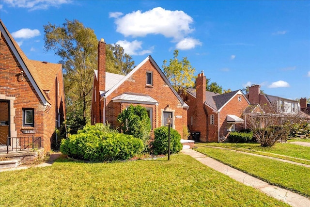 view of front of property with a front yard and brick siding