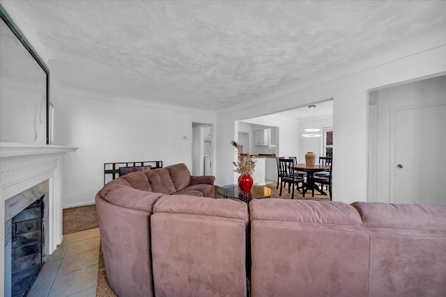 living area with a textured ceiling and a premium fireplace