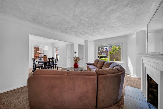 living room featuring a textured ceiling, carpet flooring, a fireplace with flush hearth, and baseboards