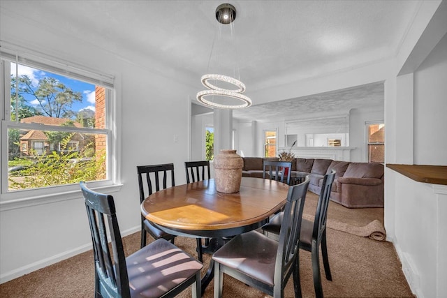 dining area with carpet floors, baseboards, and an inviting chandelier