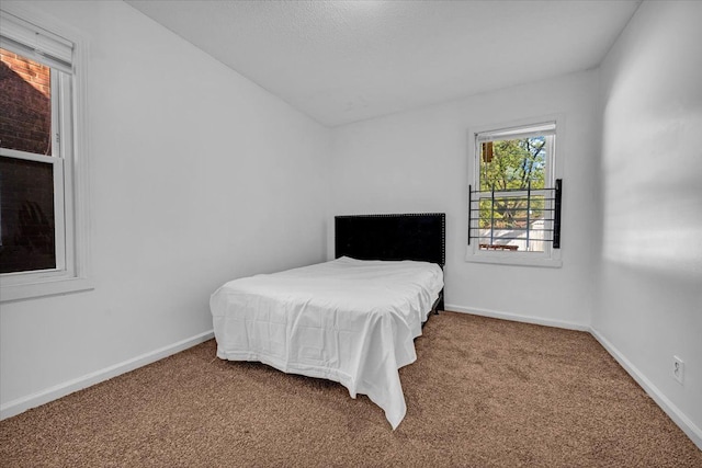 bedroom with carpet floors and baseboards