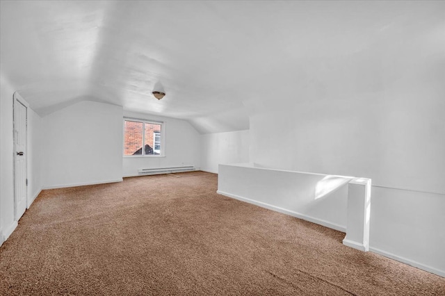 additional living space featuring vaulted ceiling, carpet floors, baseboard heating, and baseboards