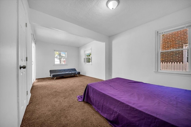 carpeted bedroom featuring a textured ceiling