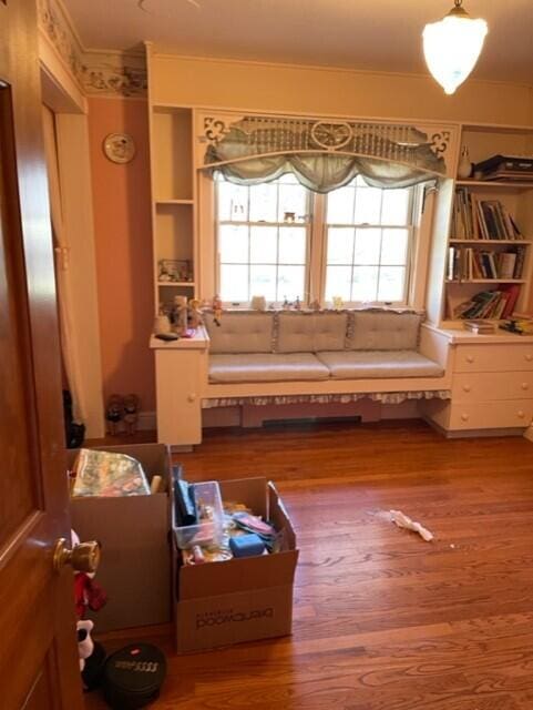 miscellaneous room with hardwood / wood-style flooring, ornamental molding, and a wealth of natural light