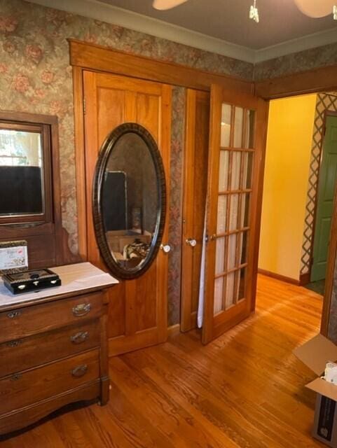 interior space with crown molding and wood-type flooring