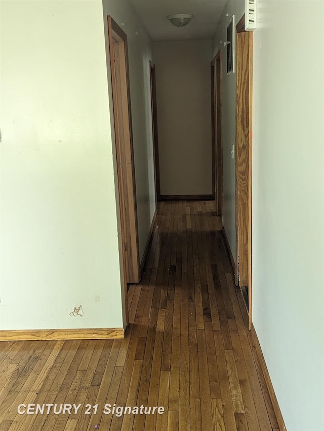 corridor with dark hardwood / wood-style flooring