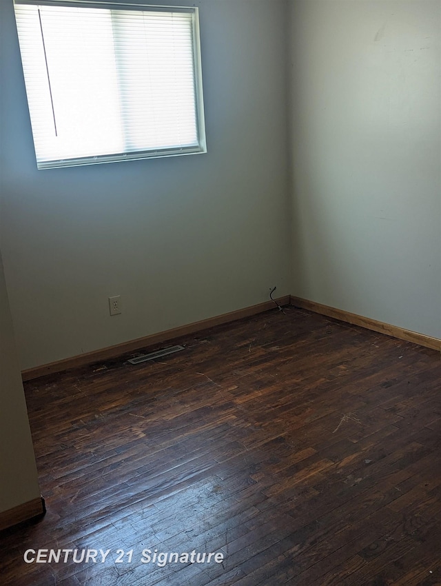 unfurnished room featuring dark wood-type flooring