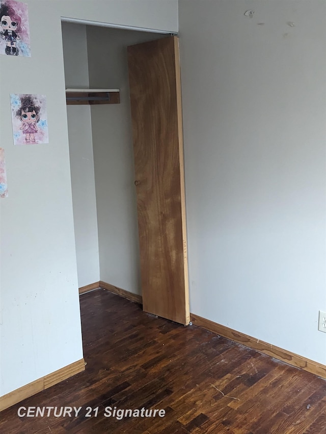 interior space with dark hardwood / wood-style flooring and a closet