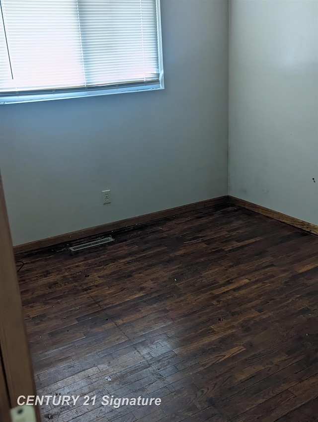 spare room with dark wood-type flooring