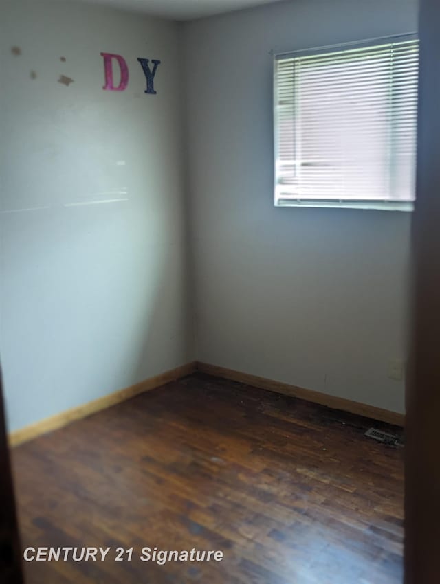 spare room featuring dark hardwood / wood-style flooring