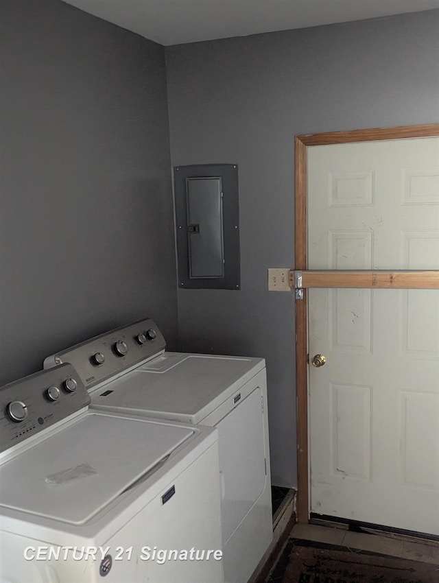 washroom with washing machine and clothes dryer and electric panel