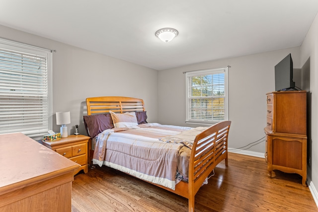 bedroom with dark hardwood / wood-style floors