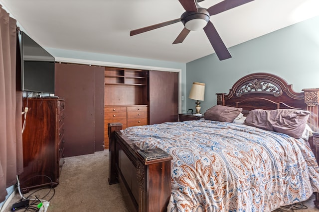 carpeted bedroom with a closet and ceiling fan