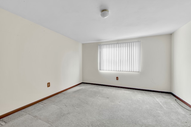 unfurnished room with light carpet