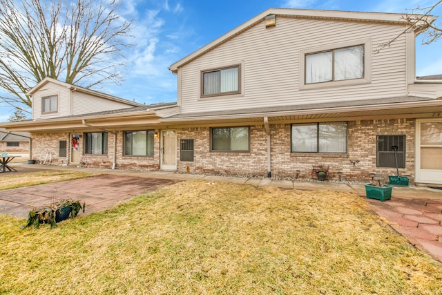 view of front of house with a patio area and a front yard