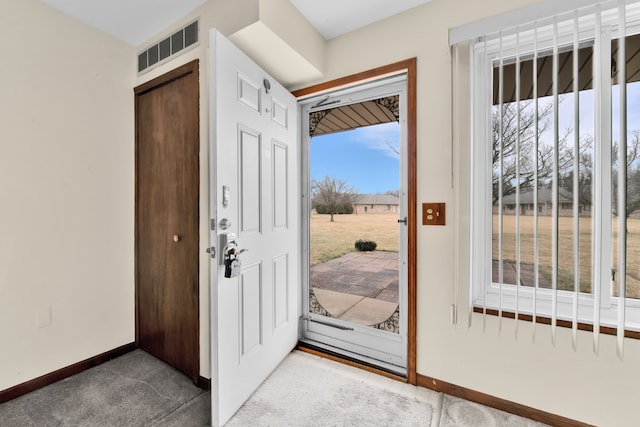 entrance foyer featuring carpet flooring