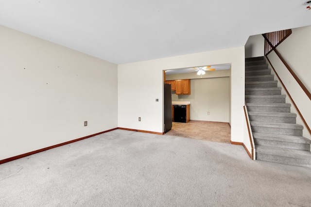 unfurnished living room with light carpet and ceiling fan