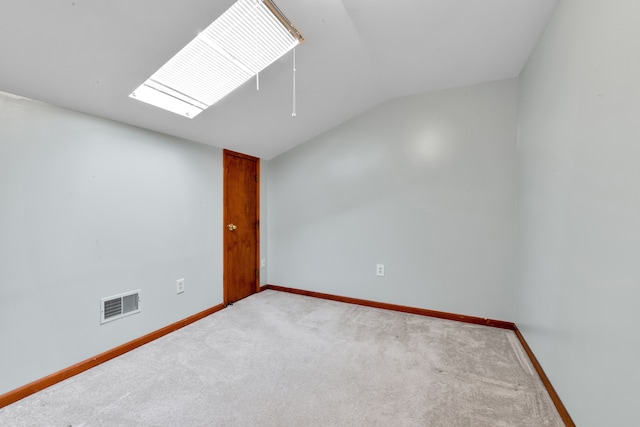 unfurnished room with lofted ceiling and carpet