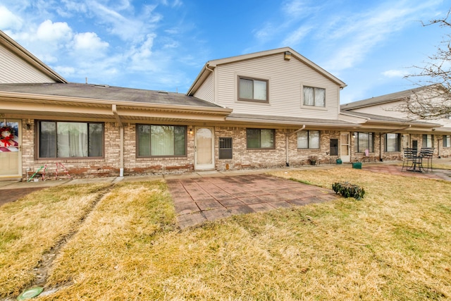 rear view of house with a patio area and a lawn