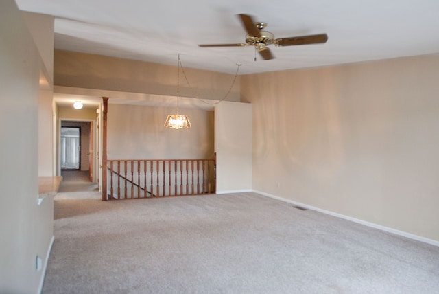 unfurnished room with ceiling fan and carpet flooring