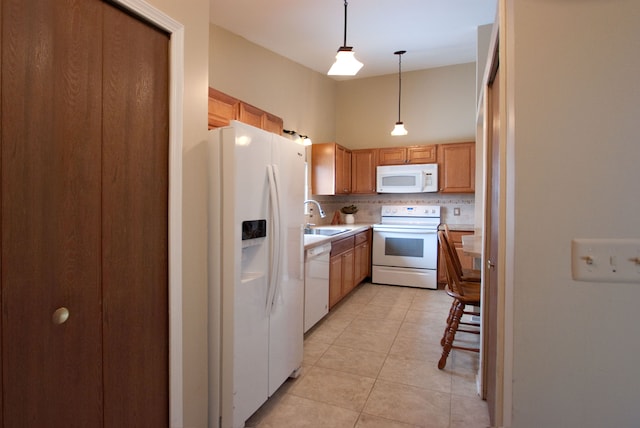 kitchen featuring light tile patterned flooring, sink, decorative backsplash, hanging light fixtures, and white appliances