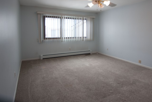 spare room with ceiling fan, a baseboard radiator, and carpet flooring