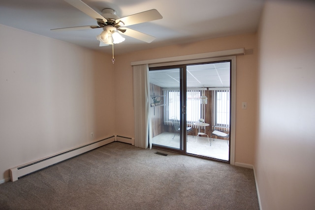 empty room with a baseboard heating unit, ceiling fan, and carpet flooring