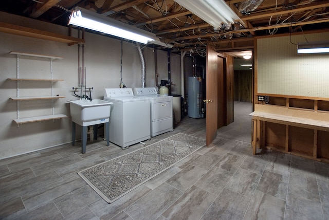 laundry area with washer and dryer, sink, water heater, and a workshop area