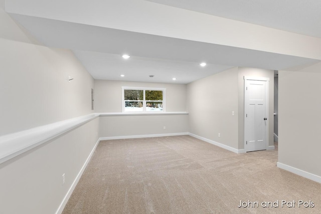 basement featuring light carpet