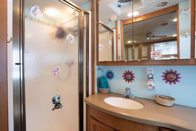 bathroom with vanity, ceiling fan, and a shower with shower door