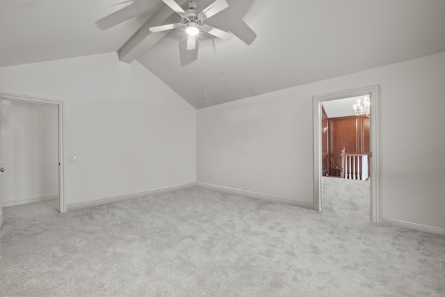 additional living space with lofted ceiling with beams, ceiling fan, light carpet, and baseboards