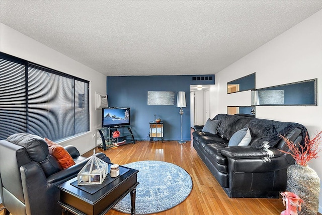 living room with hardwood / wood-style flooring and a textured ceiling