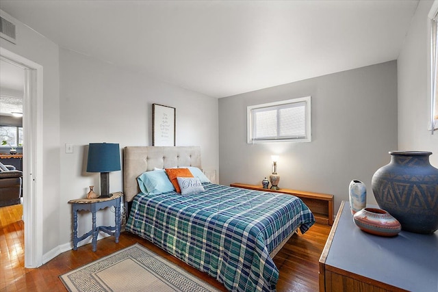 bedroom with dark hardwood / wood-style flooring