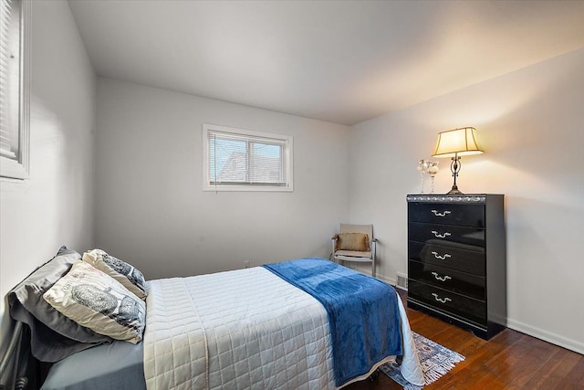 bedroom with dark hardwood / wood-style flooring